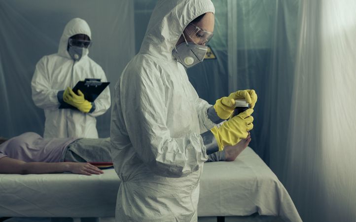 Doctors preparing medication for sick woman