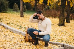 Trendy male with backpack and camera