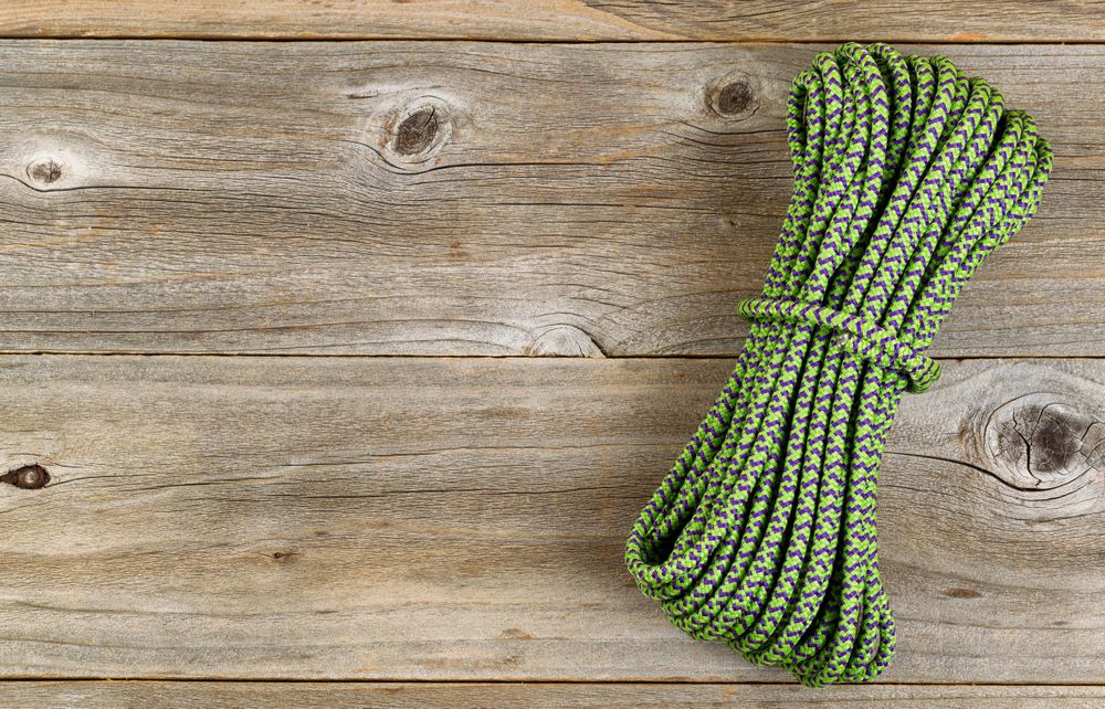 New nylon climbing rope on rustic wood