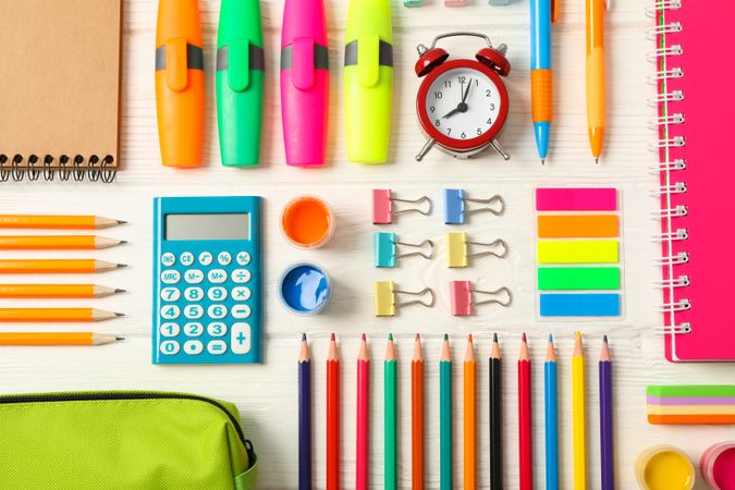 Flat lay composition with school supplies on wooden background