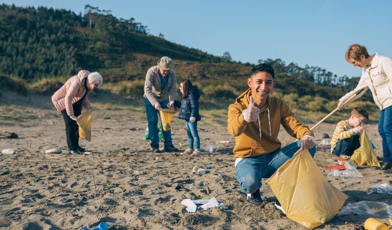 Young man cleaning the beach