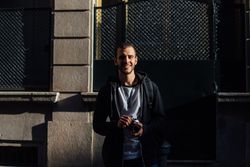 Man smiling while holding camera