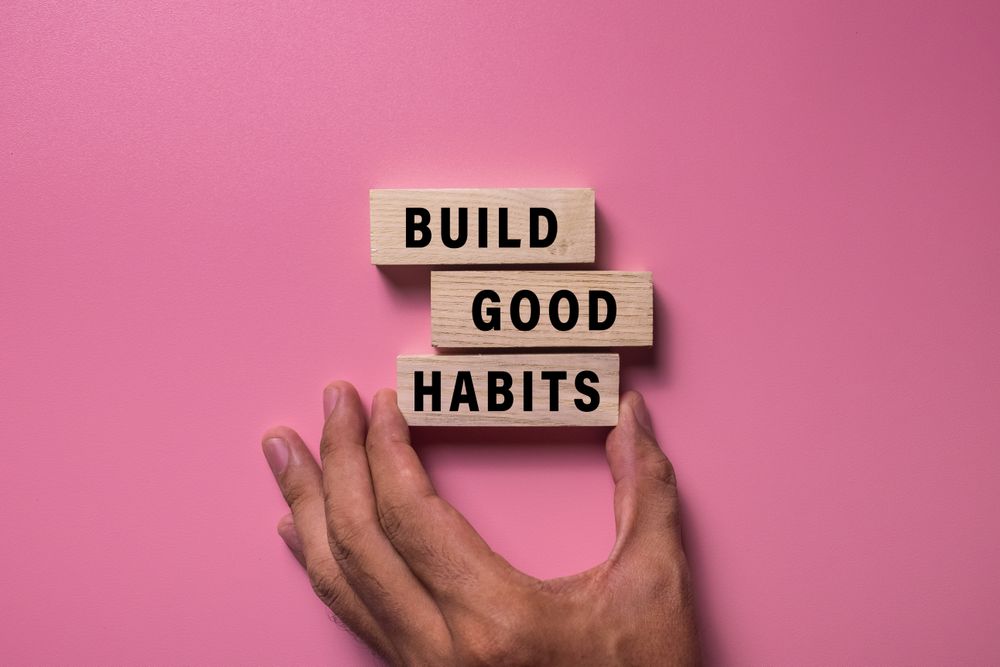 build good habits words symbol on wooden blocks isolated on pink background. motivational words concept