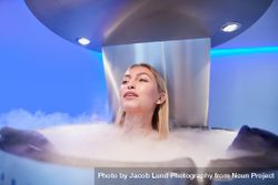 Blonde woman relaxing in cryotherapy chamber 5aXjNK