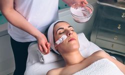 Female resting in spa while having a clay mask applied