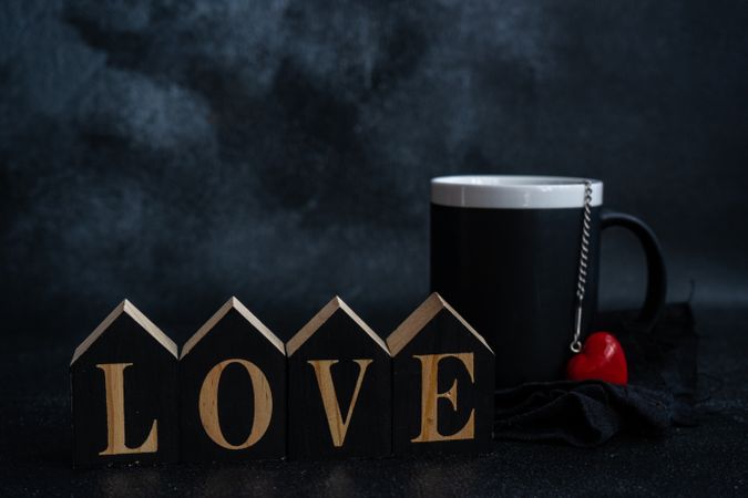 Mug with heart ornament and blocks spelling the word "love"