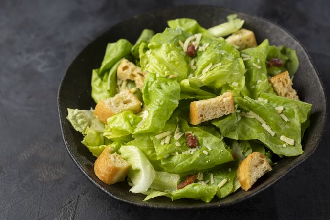 Caesar salad with croutons and bacon.