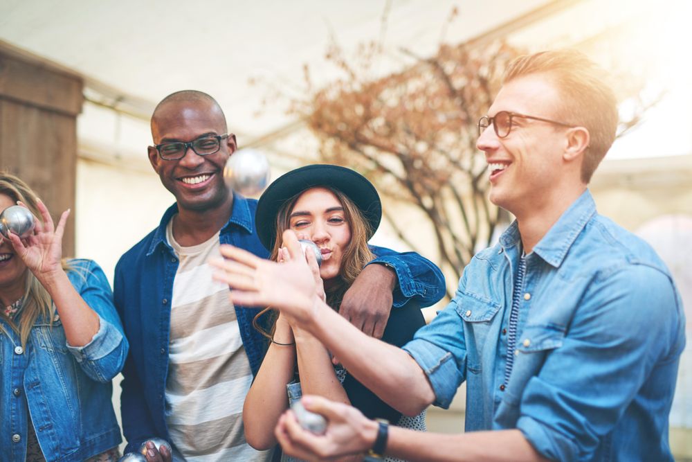 Multi-ethnic group of friends joking around outside