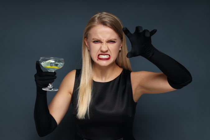 Concept of Halloween, young woman on dark background
