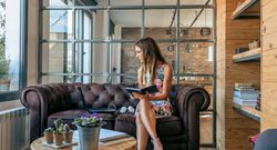 Businesswoman working with laptop sitting on the sofa