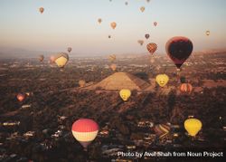 Colorful hot air balloons in flight over pyramids in Teotihuacan Valley 4MrMlb