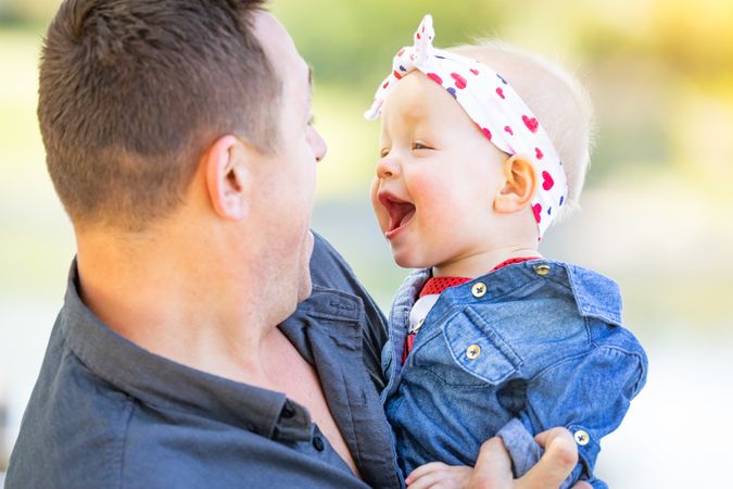 Young Father and Baby Girl At The Park