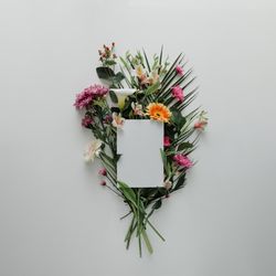 Flower bouquet on light background with paper card