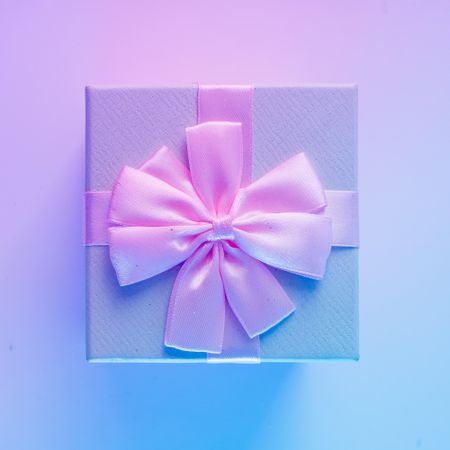 Wrapped present on vibrant bold gradient holographic colors