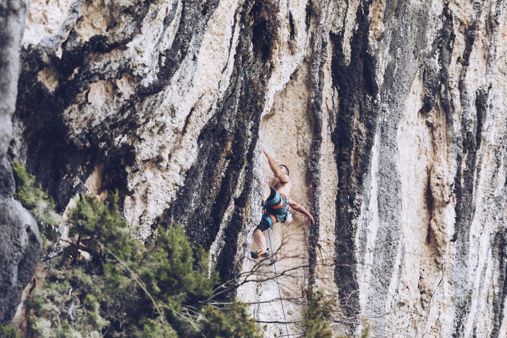 Anonymous man climbing rock