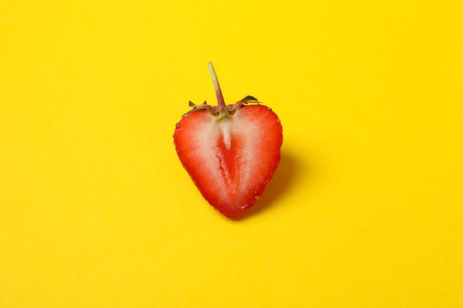Tasty strawberry on yellow background. Summer berry