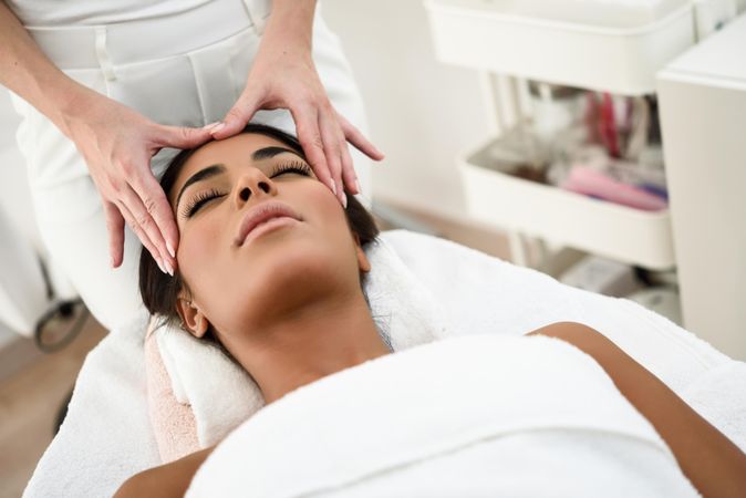 Woman receiving a facial treatment from a professional