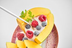 Appetizing dessert made of papaya and berries
