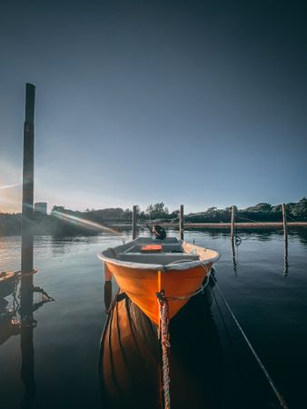 A calm boat tied to the dock