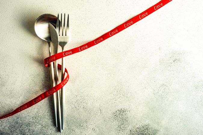 Cutlery wrapped in red ribbon