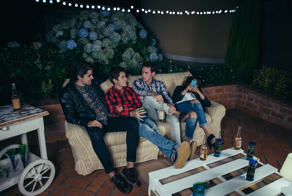 Young friends talking and drinking at a party