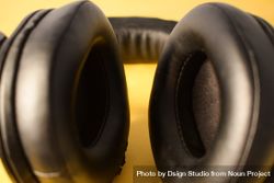 Close up of ears on headphone cushion on yellow background 4Az3Wm