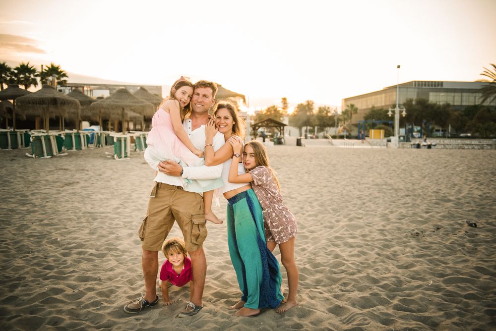 Beautiful happy family with children on beach