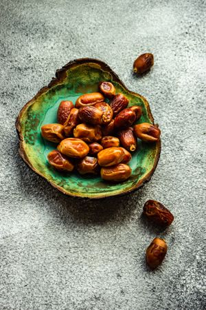 Top view of green plate of dates