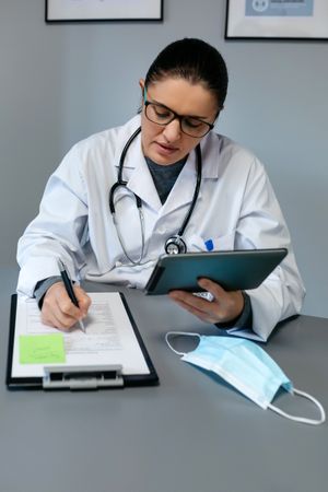 Female doctor doing online consultation with the tablet