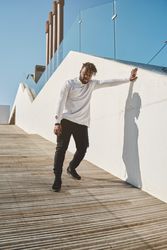 Black man standing on wooden ramp in city