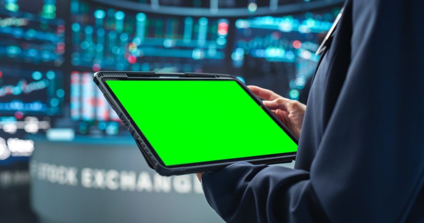 Person Holding a Tablet Computer with Green Screen Mock Up Display.