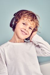 Smiling boy listening to music in headphones