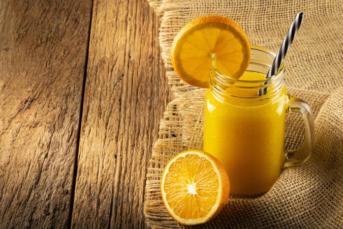 Glass with orange juice on the table.