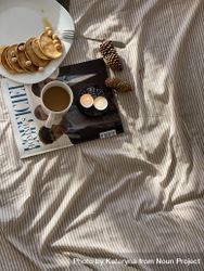 Bed with magazine, candles, breakfast and pinecones 4Z1ex5