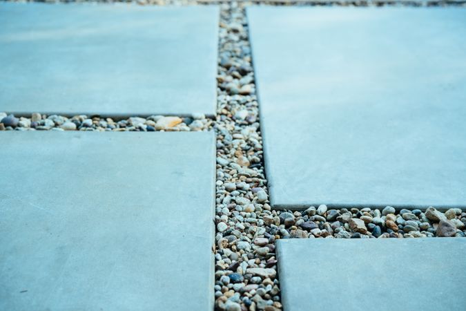 Close up of cement pavers with small rocks between