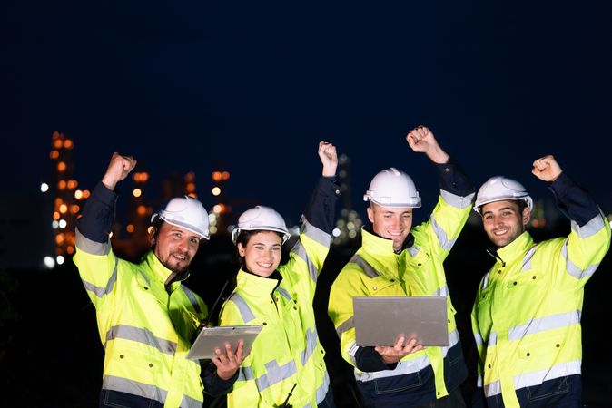 Group of engineer raising hands up for finish working night shift at petrochemical