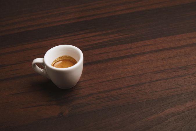Single espresso shot on wooden table