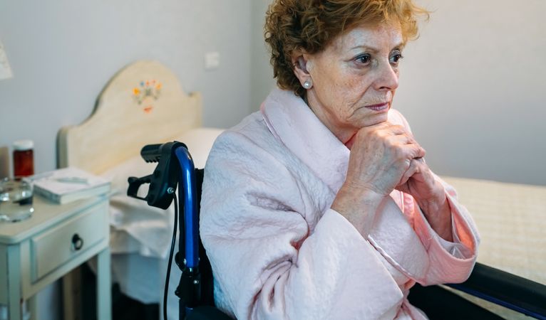 Mature woman in a wheelchair alone