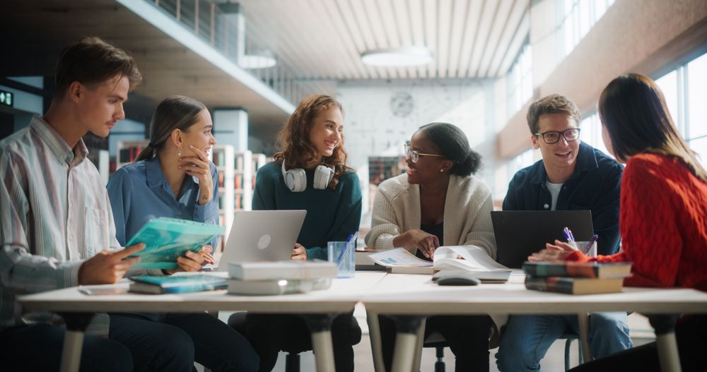 Diverse Group of Students Engaged in a Study Session at a Modern Library.