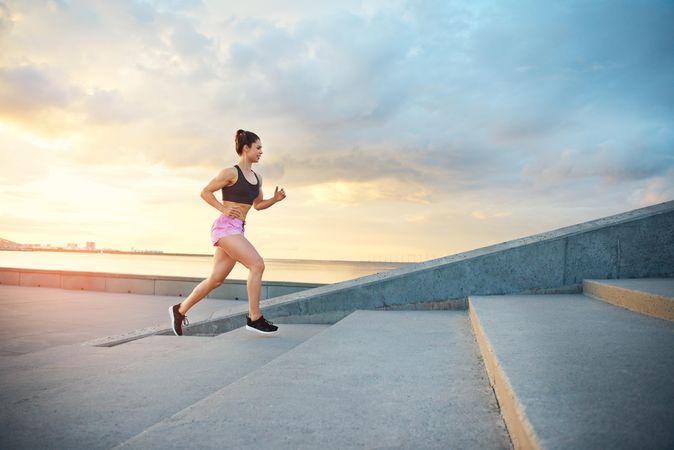 Woman exercising on stairs in morning light