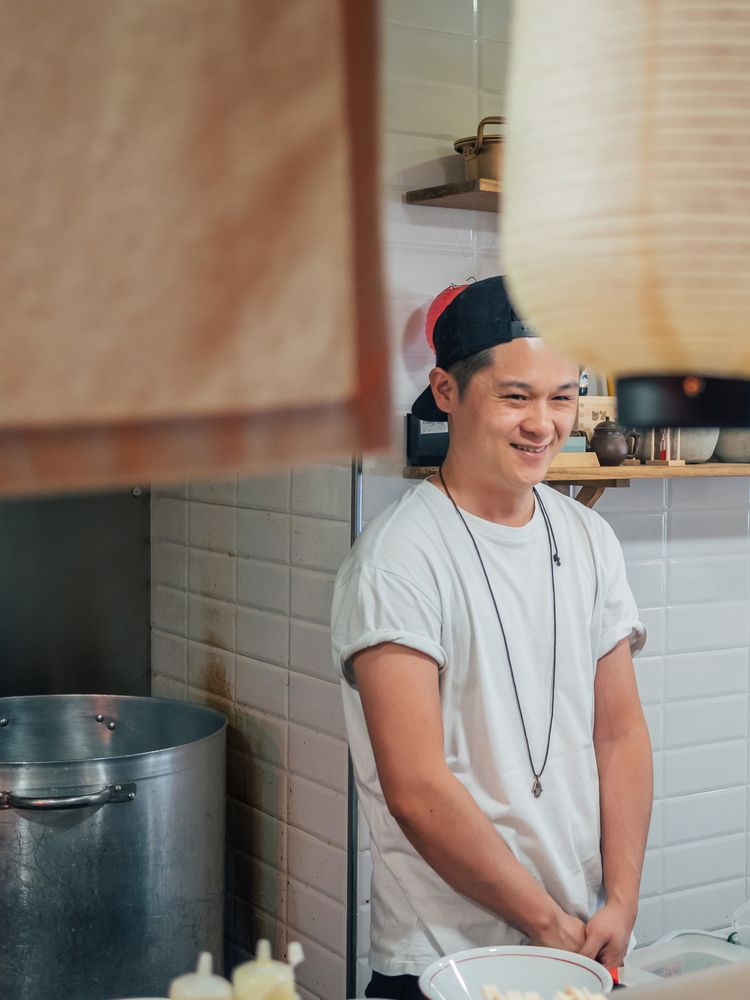 Asian male cook standing in kitchen