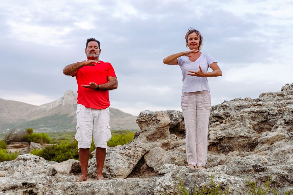 Couple meditating on rock