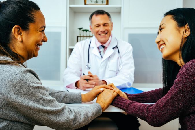 Two patients receiving good news in doctor’s office