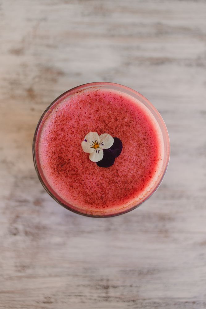 Delicious pink smoothie with frothy in glass