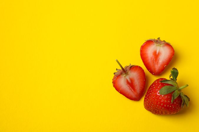 Tasty strawberry on yellow background. Summer berry