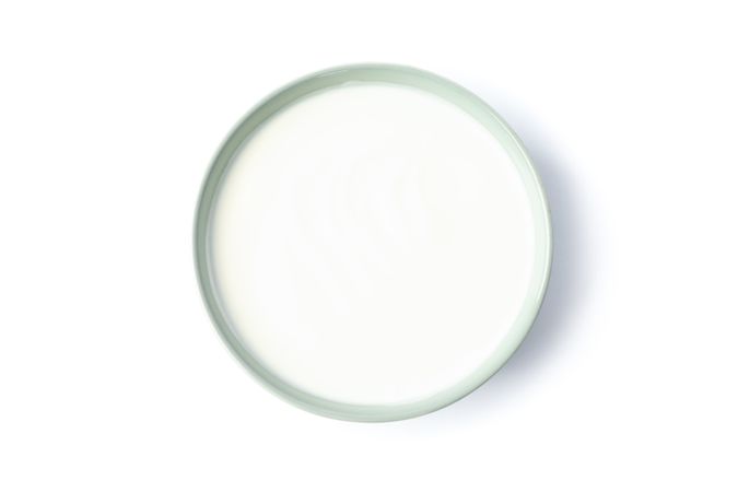 Bowl of sour cream yogurt isolated on light background