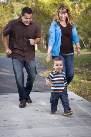 Happy Family Walking In The Park
