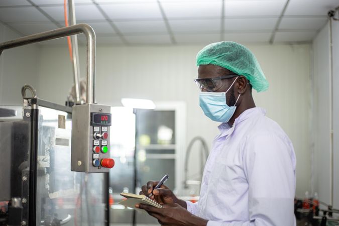 Black man performing inspection in a factory