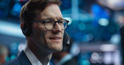 Adult Man Wearing Glasses and Headphones, Researching Investment Possibilities for International Business Corporations