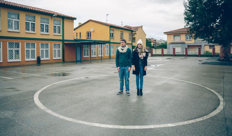 Couple standing together in circle in sports court